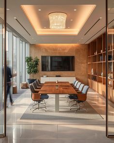 a conference room with large wooden table and chairs