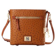 Display your team spirit in rare fashion with this New York Yankees Zip crossbody. Crafted by Dooney & Bourke, it features the unique look and texture of ostrich leather and multiple pockets to help keep your must-have items easily accessible. An adjustable strap makes carrying around this New York Yankees purse comfortable and effortless. Rare Fashion, Ostrich Leather, Must Have Items, Dooney & Bourke, Crossbody Purse, New York Yankees, Team Spirit, Dooney Bourke, Cross Body Handbags