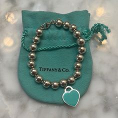 Tiffany & Co Enamel Heart Tag Beaded Bracelet. Barely Worn, Very Minor Wear. Authentic 925 With Tiffany & Co Engravings On Both Sides Of The Tag. One Side Of The Heart Tag Is Enameled Tiffany Blue, The Other Side Is Engraved Silver “Please Return To Tiffany & Co New York 925”. Includes Tiffany & Co Pouch. Tiffany Blue Bracelet, Luxury Silver Beaded Bracelets As Gift, Elegant Silver Beaded Bracelets For Valentine's Day, Luxury Sterling Silver Beaded Bracelets For Gifts, Tiffany And Co Bracelet, Jewelry Tiffany, Return To Tiffany, Heart Tag, Tiffany Co Jewelry