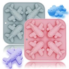 two plastic trays with different shapes of planes