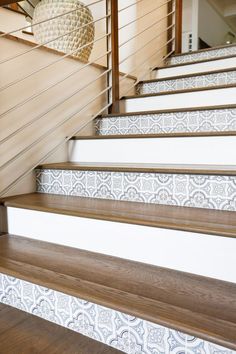 some white and brown stairs with wooden handrails