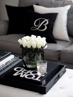 a coffee table with flowers and books on it