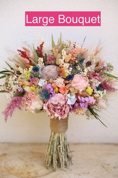 the large bouquet is filled with flowers and foliage