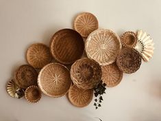 the wall is decorated with woven baskets and seashells