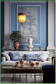 a living room with blue walls and white furniture