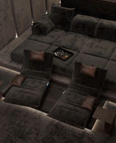 a living room filled with lots of grey couches