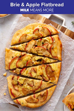 an apple and cheese pizza on top of parchment paper with the title, brie & apple flatbread milk means more