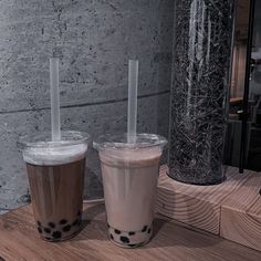 two drinks sitting next to each other on a table