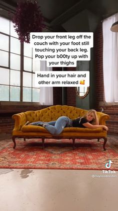 a woman laying on top of a yellow couch