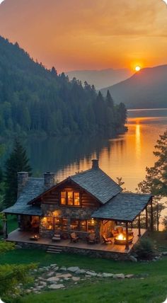 the sun is setting over a lake with a cabin on it