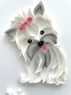 a white dog with a pink bow on it's head is shown in the shape of a paper cutout