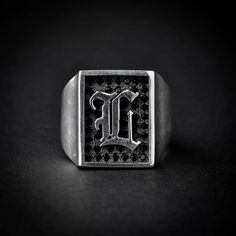 A handmade sterling silver 925 rectangle shape old english letter signet ring with a border black stones.Each ring is cleaned and polished with care.The weight of the ring may vary according to size.Aprrox weight: 9.90grTop measurements: Width - 14.5mm | Height - 17mmThe ring is made of sterling silver 925 and is water resistant.The ring is set with black zircons.This ring is available in more shapes!Oval | Octagon | RoundHere are some listings that you might also love:https://www.etsy.com/il-en Silver Rectangular Initial Ring In Classic Style, Silver Rectangular Initial Ring Classic Style, Classic Silver Rectangular Initial Ring, Silver Monogram Signet Ring, Classic Black Signet Ring With Initials, Black Personalized Sterling Silver Signet Ring, Black Sterling Silver Jewelry With Initials, Old English Letters, Ring Initial