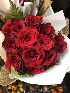 a bouquet of red roses sitting on top of a table