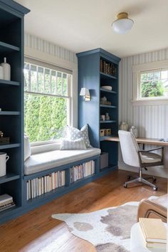 a home office with built in bookshelves and a window seat