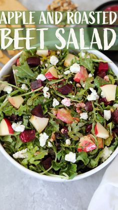 a salad with apples and roasted beets in a white bowl on top of a table