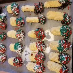 an assortment of desserts on a baking sheet with sprinkles and icing