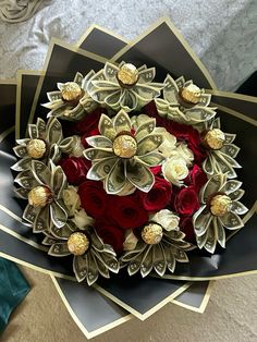 a bouquet of flowers is sitting on top of some folded up cards and brooches