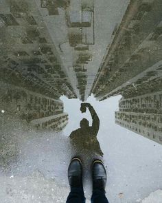 a person standing in the middle of a street with their feet up on the ground