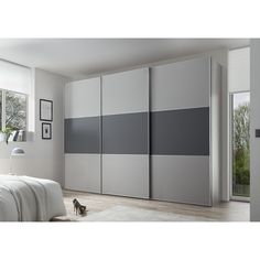 an image of a bedroom setting with grey and white color blockings on the doors