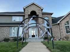 a house that has been decorated with white streamers on the front door and walkway