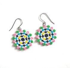 Celebrate summer with these beautiful hand-woven earrings. With a playful pattern of hand-woven beads in summery shades, these earrings convey a cheerful and energetic appearance. A perfect choice for a stylish touch on warm days. The silver-colored ear hooks are made of stainless steel/stainless steel (durable, hypo-allergenic, of high quality and do not discolour). It is also possible to opt for gold-colored earrings. The pendant has a diameter of approximately 3.5 cm (1.38") 🔴 Tips for jewel Multicolor Round Earrings For Summer, Handmade Colorful Beaded Round Earrings, Handmade Multicolor Flower Earrings With Round Beads, Beaded Multicolor Flower Earrings For Summer, Multicolor Beaded Flower Earrings For Summer, Colorful Round Earrings For Beach, Summer Multicolor Beaded Flower Earrings, Multicolor Beach Earrings With Ear Wire, Multicolor Round Flower Earrings