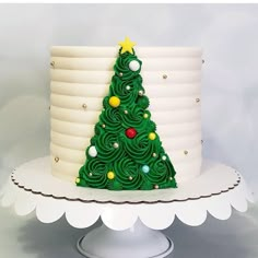 a green christmas tree cake sitting on top of a white plate