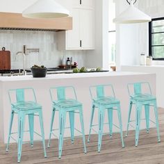 four blue stools sit in front of a kitchen island