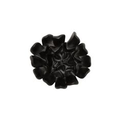 a black flower is shown against a white background in this image, it appears to be made from plastic