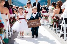 two young children are walking down the aisle