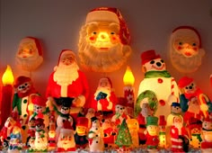 christmas decorations are displayed on the wall with santa's hats and other holiday items