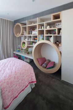 a room with a bed, shelves and toys in the shape of a circular object