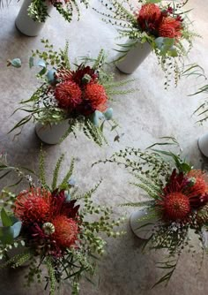 two vases filled with flowers on top of a table