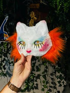 This is a  clown themed cat mask Halloween Cat Design Mask For Costume Party, Cat Design Eye Mask For Costume Party, Halloween Masquerade Mask With Cat Ears, Cat Design Eye Mask For Masquerade, Fun Full Face Halloween Mask, Masquerade Eye Mask With Cat Design, Fun Full-face Halloween Masks, Halloween Cat Design Masks And Prosthetics With Cat Ears, Halloween Cat Design Masks With Cat Ears