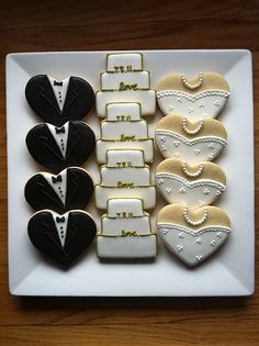 a white plate topped with cookies covered in black and white icing