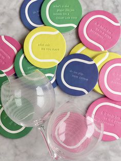 tennis ball coasters and wine glass on marble counter top with personalized drink glasses