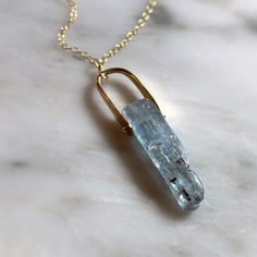 "This necklace features a beautiful raw blue kyanite stone encased by a 14k gold fill looped band with a bar of solid .935 silver holding it in place. The chain is a delicate 14k gold filled chain of very high quality that will last. This is a piece that you won't find anywhere else. Unique and every stone is natural and one of a kind. ● Chain: 14k gold filled chain ● Chain Length: 16\" long  ● Stone: Kyanite ● Metal band: 14k Gold Fill ● Nickel and lead free // Shop the matching EARRINGS here! Piercing Styling, Blade Necklace, Kyanite Necklace, Blue Stone Pendant, Kyanite Jewelry, Raw Stone Necklace, Woodland Park, Loop Bands, Rock Jewelry