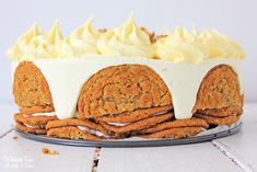 a cake with white frosting and cookies on top