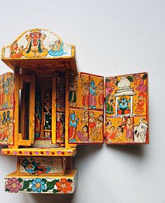 an intricately painted wooden structure on the wall