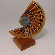 an artistically designed object on a wooden stand