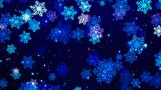 blue snowflakes on a black background with stars and sparkles in the air