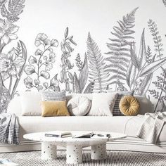 the living room is decorated in black and white with floral wallpapers on the walls