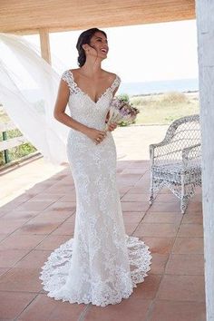 a woman in a wedding dress standing on a patio