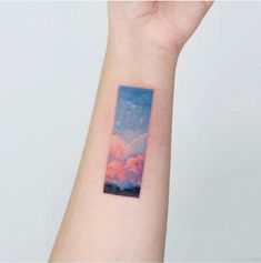 a person's arm with a small painting on the left side of their arm