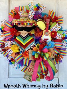 a colorful wreath with a mustache and moustache on it that says, wreath whimsy by robin