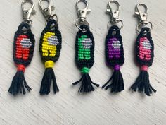 four key chains with different colored beads on them