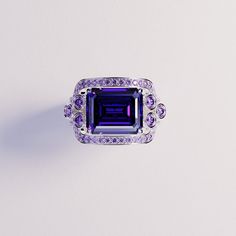 Introducing The Violet Love: This bold statement ring is perfect for any occassion. As a gift for her, a wedding ring or a gift for yourself - because you deserve it - it is guaranteed to impress. This ring is made as a 3-in-1 triple ring set. 2 perfectly fitting bands to complement the big bold center main ring. A bold and beautiful simulated amethyst sits like a crown in the center of a gemstone halo. The sides covered with beautiful simulated diamonds and purple enamel. Underneath you have pr