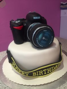 a birthday cake with a camera on top