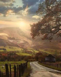 a rural country road in the mountains at sunset