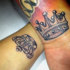 two people with matching tattoos on their arms, one has a crown and the other has a skateboard