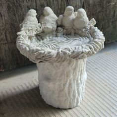 a white vase sitting on top of a wooden floor